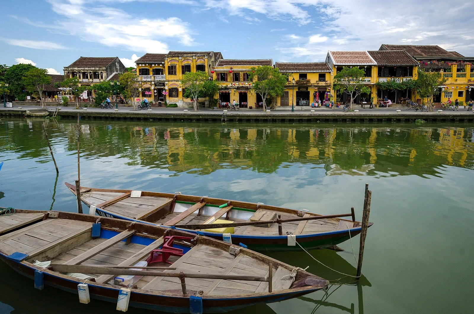 Wooden boats and riverside houses in Hoi An